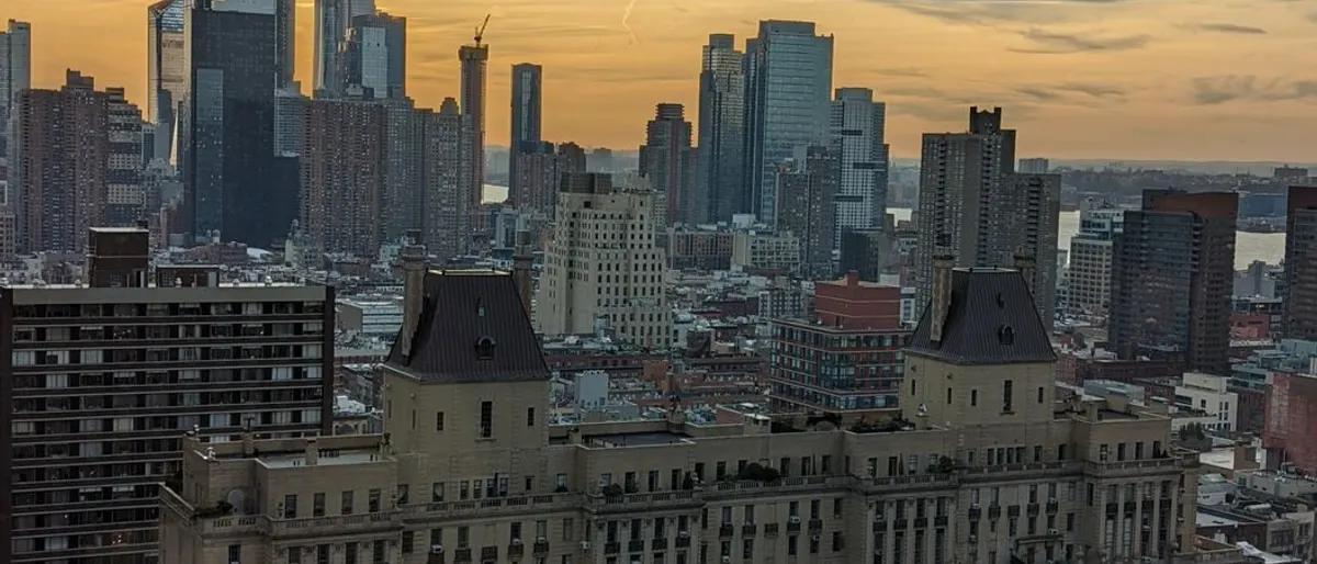 The Midtown Manhattan skyline at golden hour above the rooftops of Hell's Kitchen