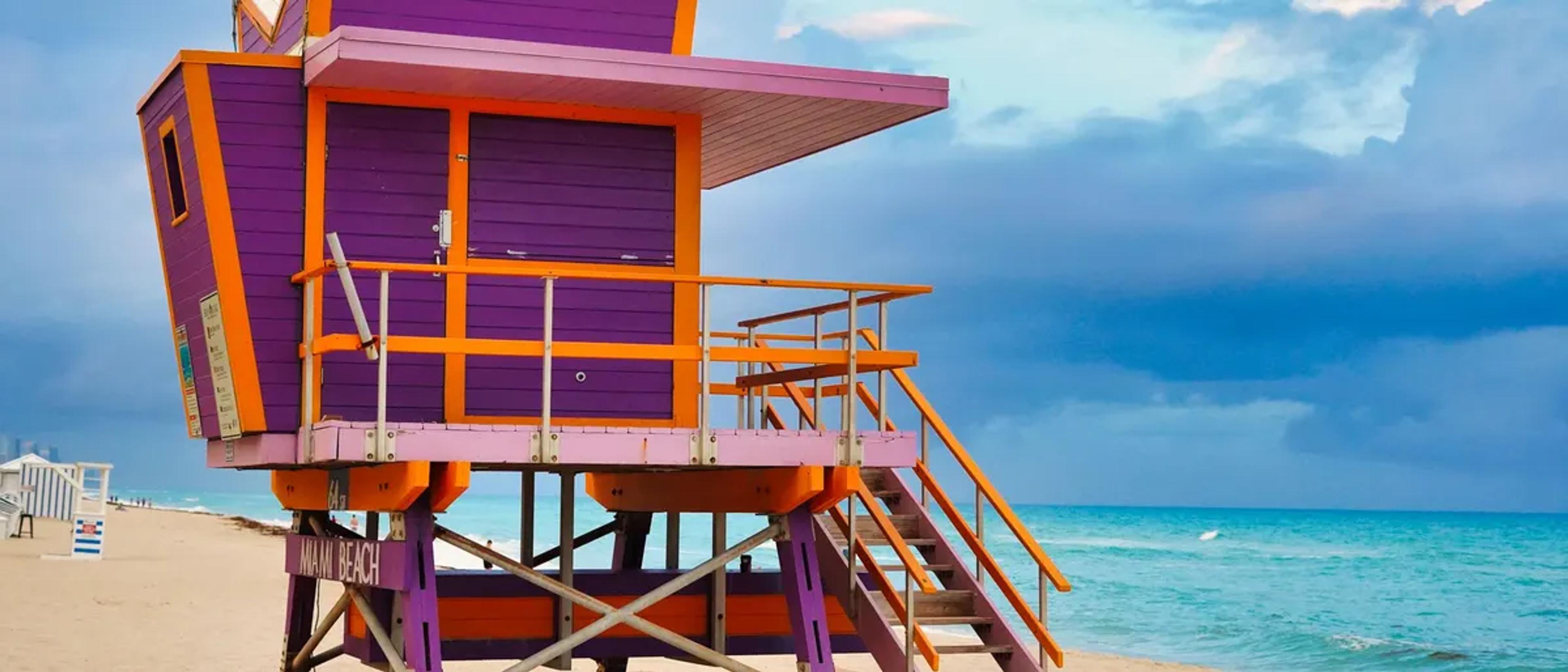 A colorful lifeguard tower on the sand at Miami Beach
