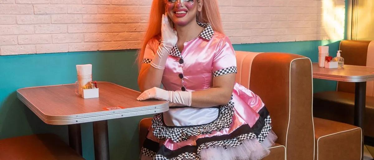 Drag performer in a diner booth at brunch