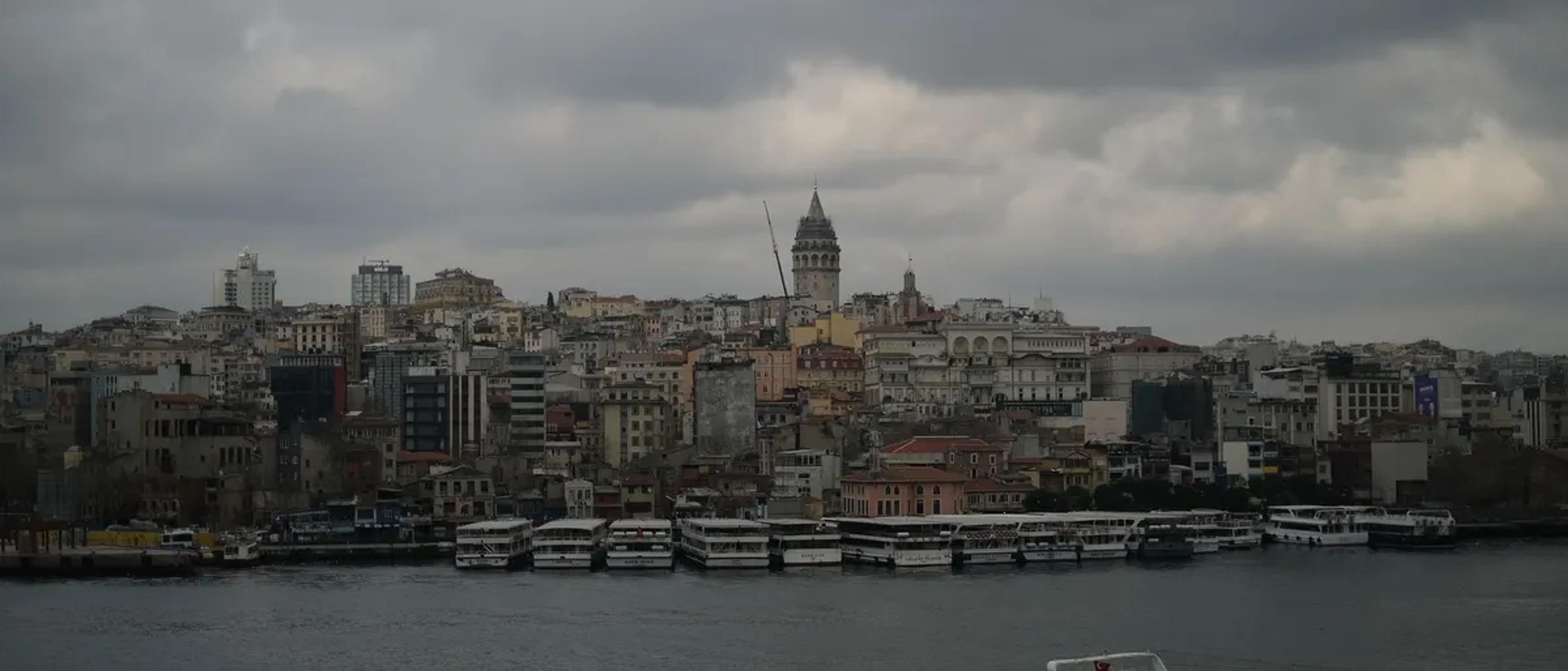 Istanbul skyline with Galata Tower under an overcast sky across the water