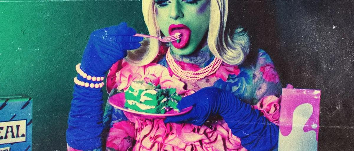 Drag performer in vivid neon light tasting a plate of food at a colorful brunch