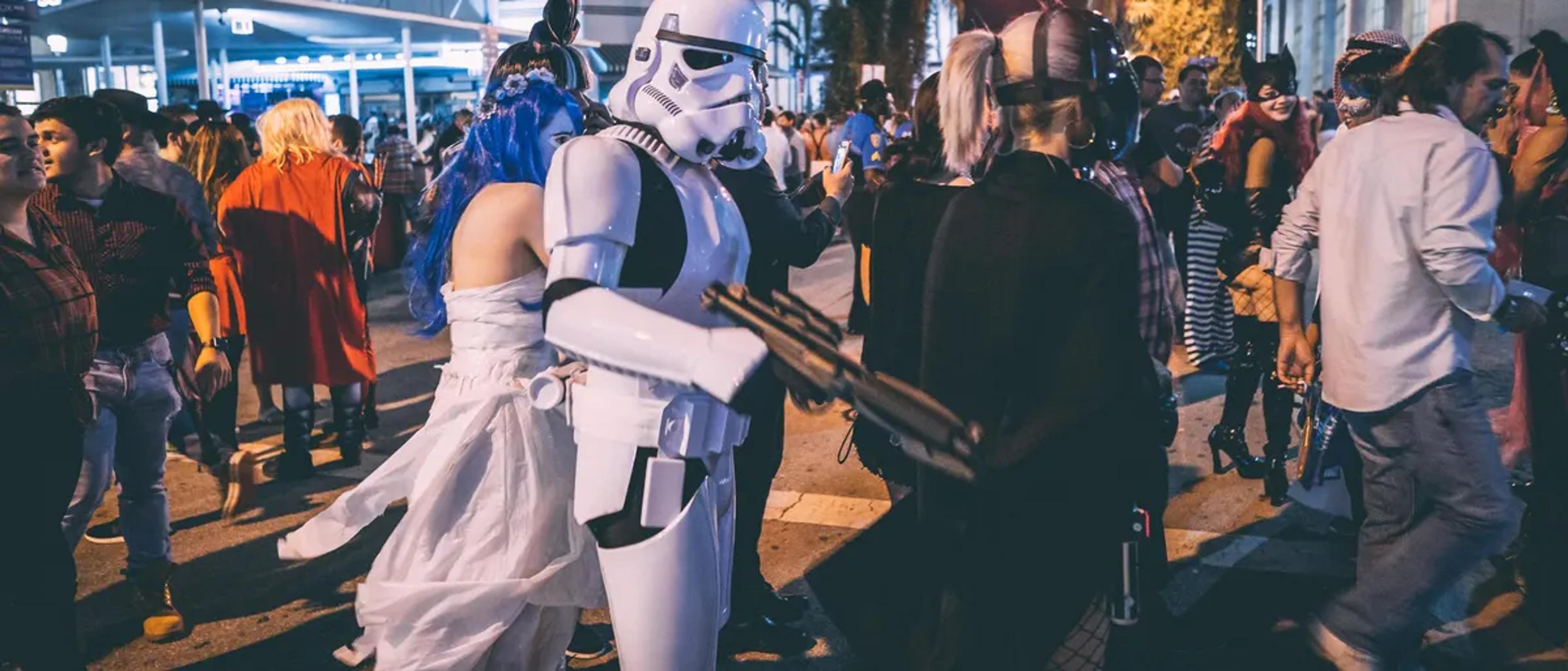 Costumed crowd filling a city street on Halloween night