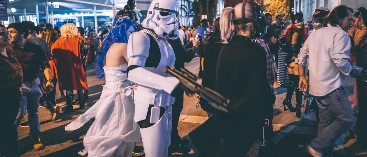 Costumed crowd filling a city street on Halloween night