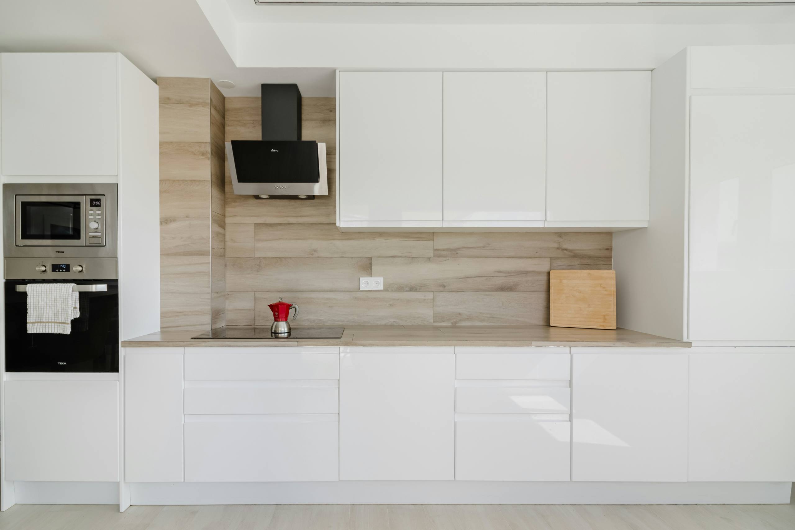 A white kitchen with clear, uncluttered counters