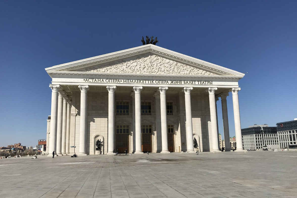 Imposing facade of the Astana Opera in Kazakhstan, a famous tourist attraction with classical columns.