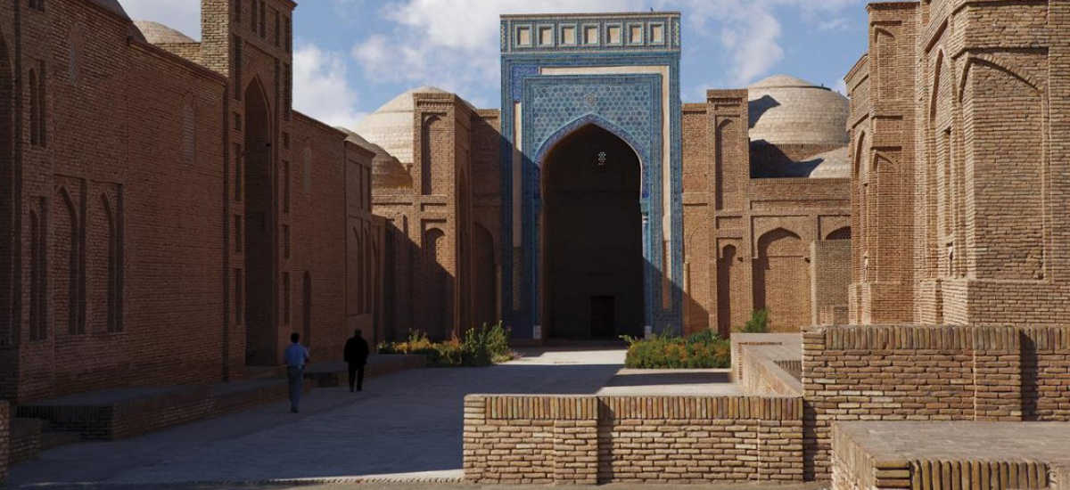 Historic Hakim al-Tirmidhi Complex in Termez, Uzbekistan: Brick architecture with a blue portal and domes.