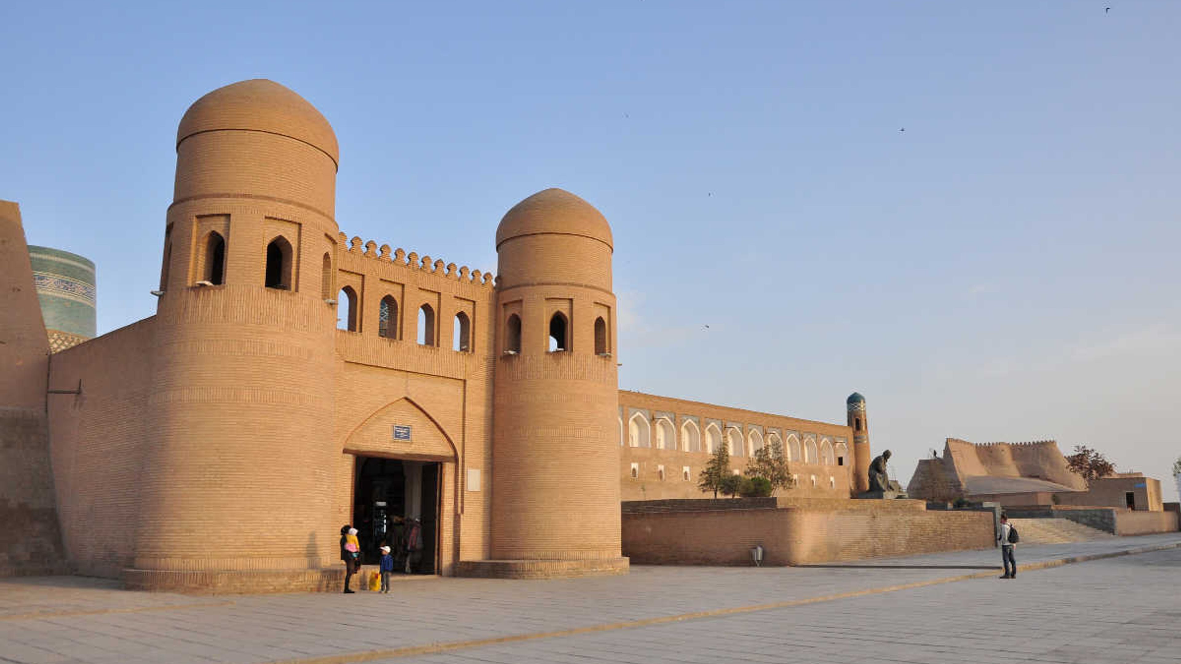 The historic Ata Darwaza gate in Khiva, Uzbekistan, a UNESCO landmark featuring distinctive twin mud-brick towers.