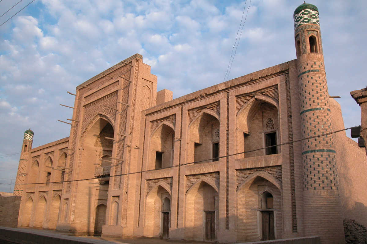 Amir Tura Madrasah in Khiva, Uzbekistan: Historic landmark with minaret in the UNESCO old town of Itchan Kala.
