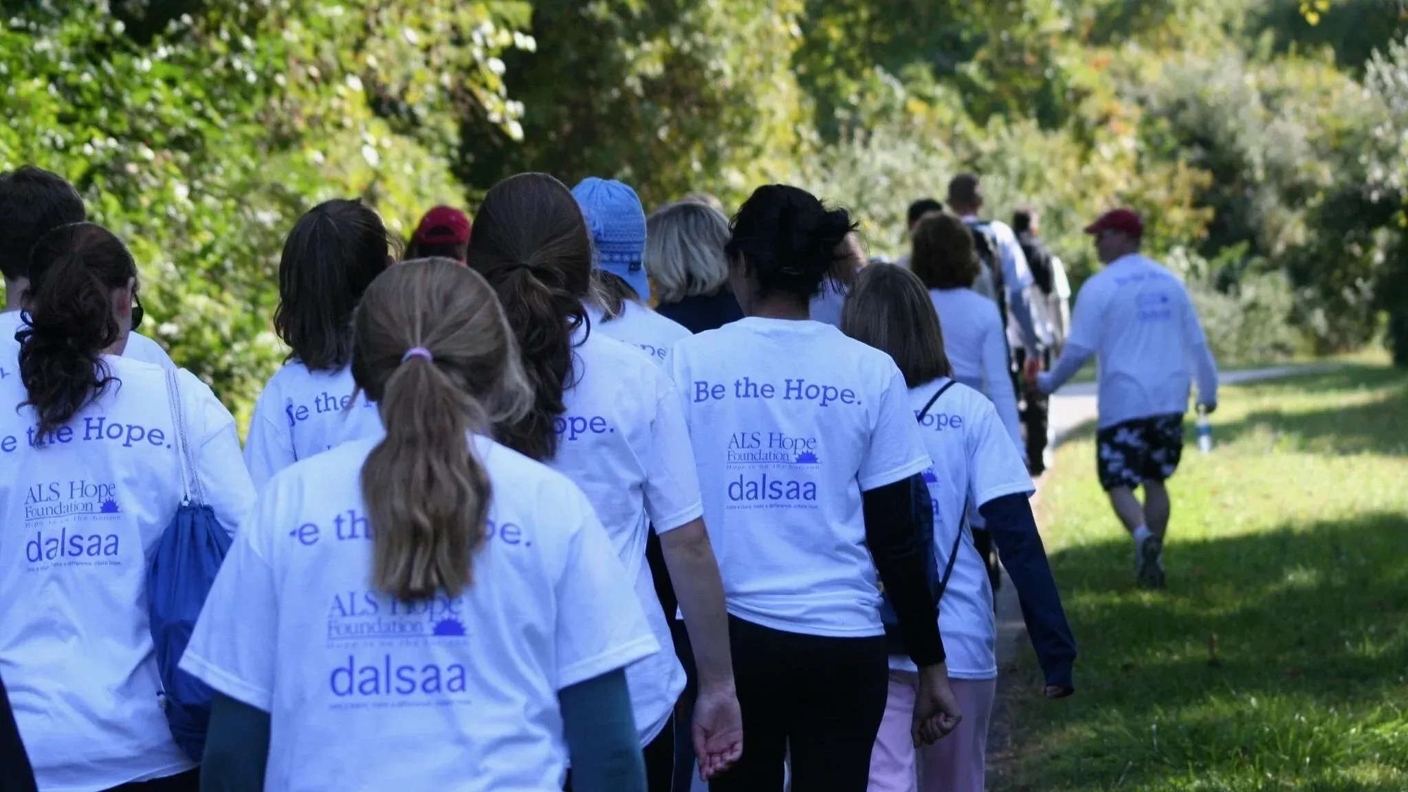 Supporters walking together at Hope Walks for ALS, in shirts that read Be the Hope.