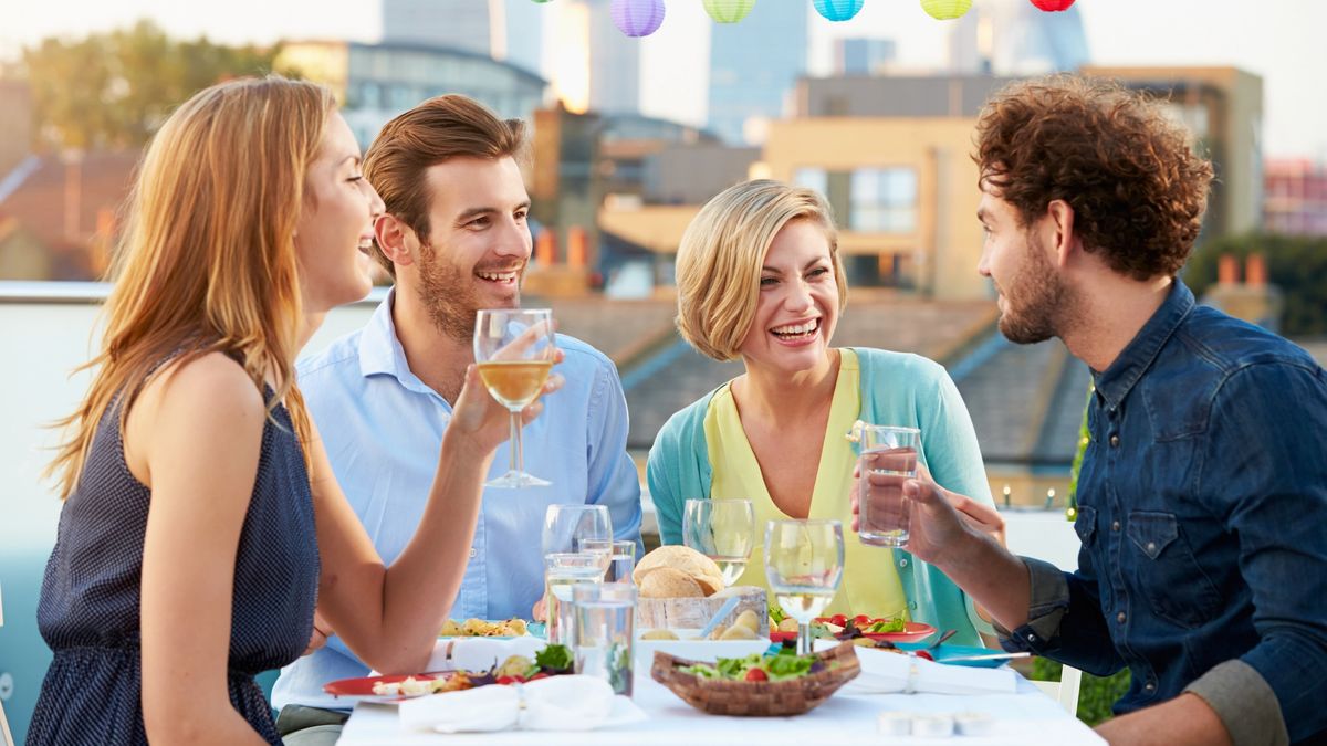 Friends enjoy a dinner while on a culinary trip.