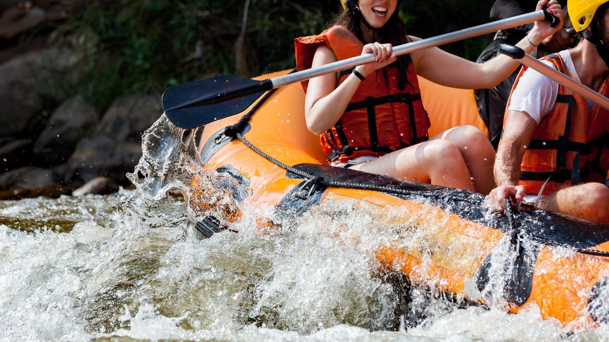 Group of people rafting in white water rapids