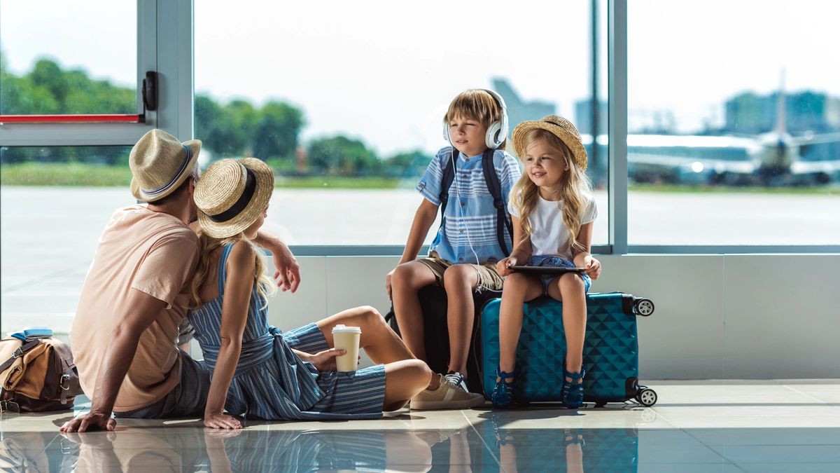 Family taking a break in the airport while traveling to their vacation destination