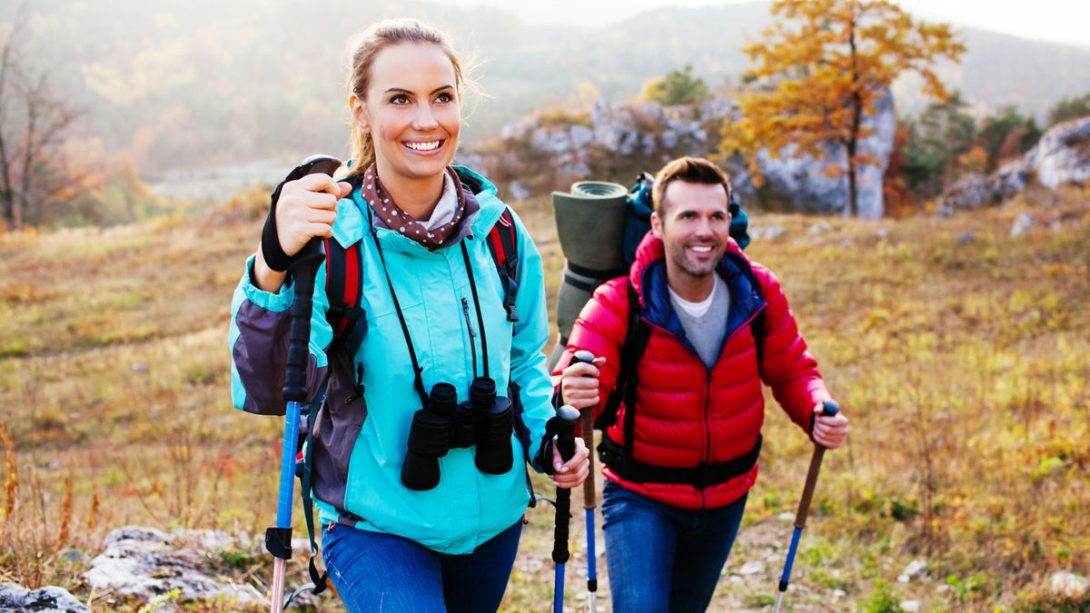 A couple finding peace and wellness on a hike in the fall