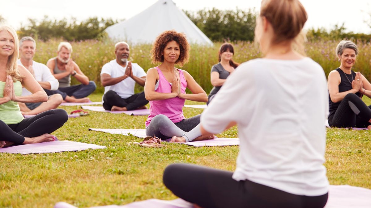 A group of tourists enjoys a mindful yoga experience while on vacation