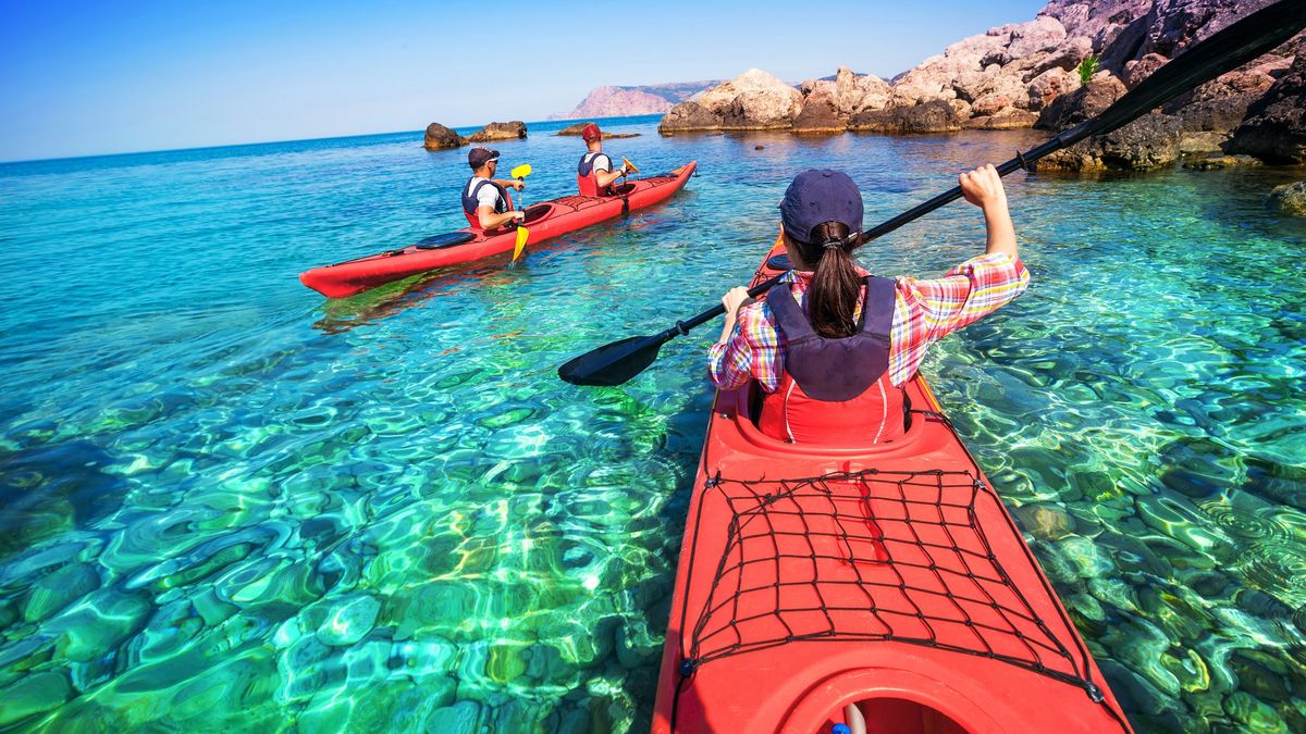 Friends meet at the kayak rental to pick up their boat and paddle in the sea