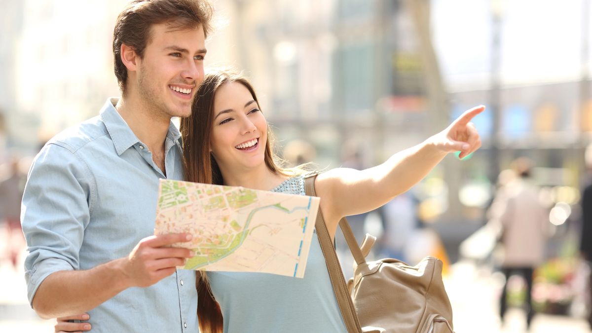A couple uses a map to explore historic downtown on their own