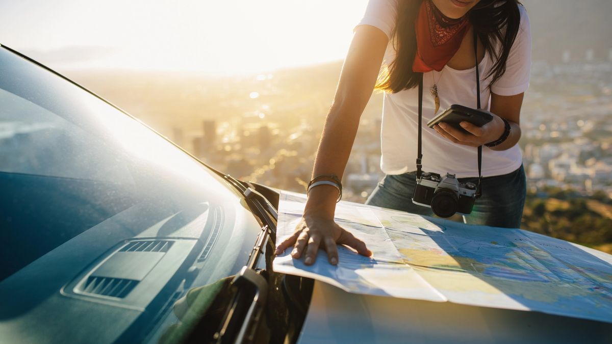 Stefanie checks the map and her phone for the next best place to stop on her road trip