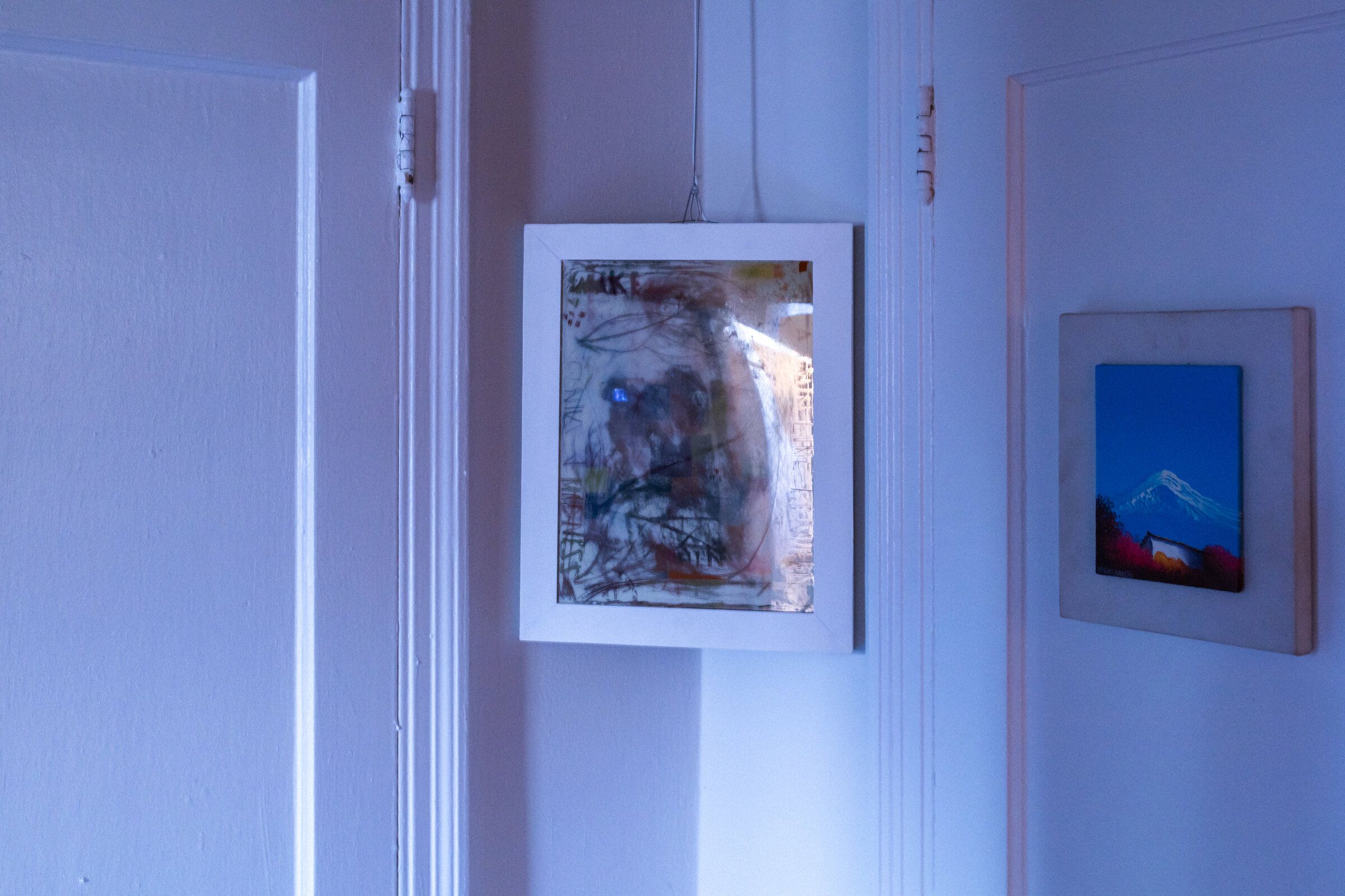 Off-angle view of genius madness mirror: from this angle the colors recede and the surface reads as a reflective gray, the original mirror underneath now dominant