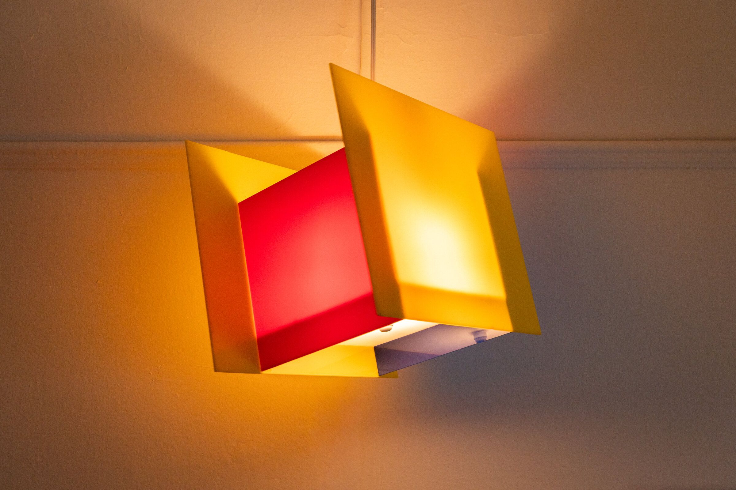 Square one with the red inner panel visible at the top, yellow outer panels framing the lit center