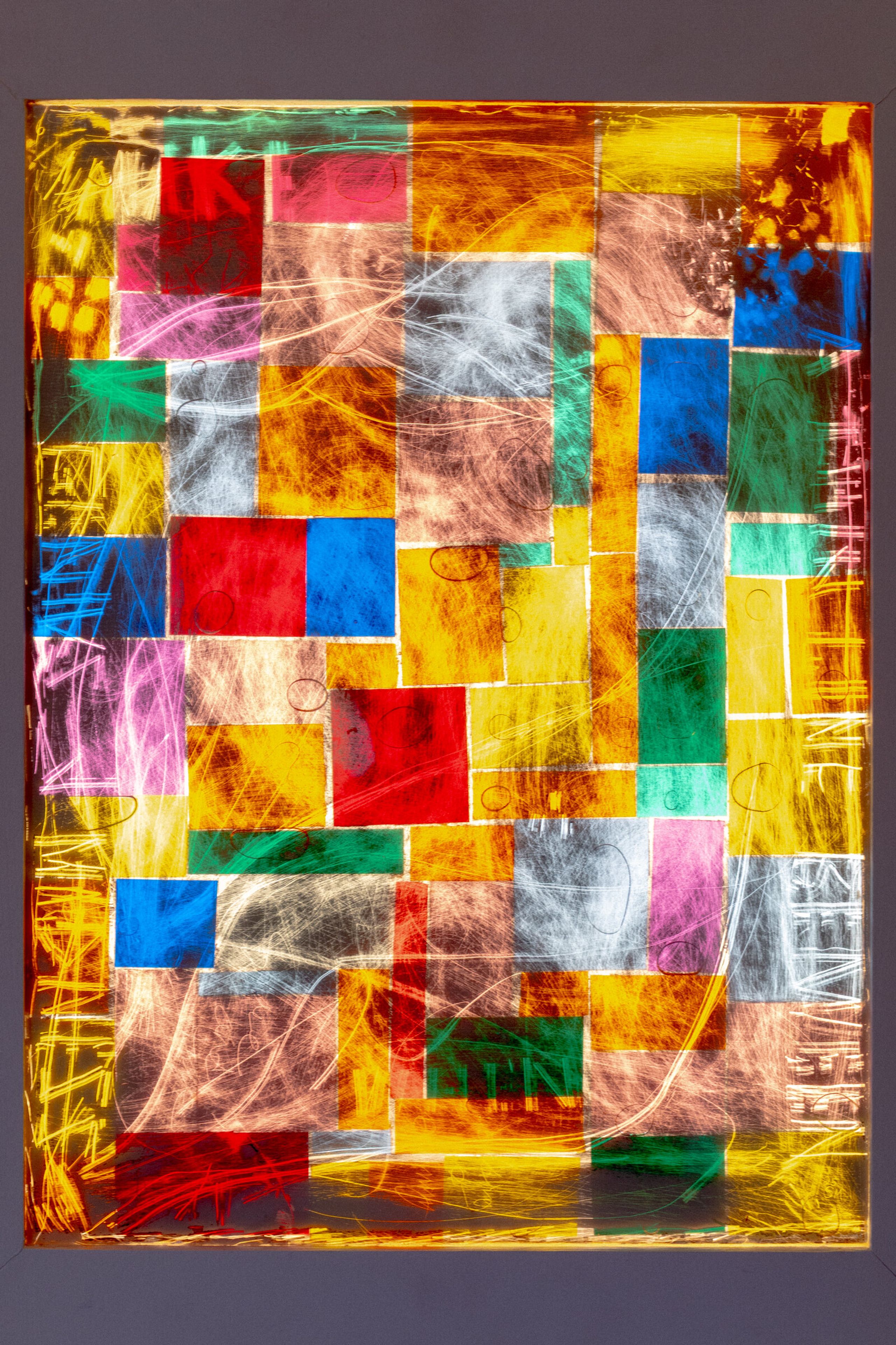 Full face of genius madness mirror without frame visible: colored squares densely packed across the surface, white gesture marks overlaid, text faintly visible along the edges in yellow