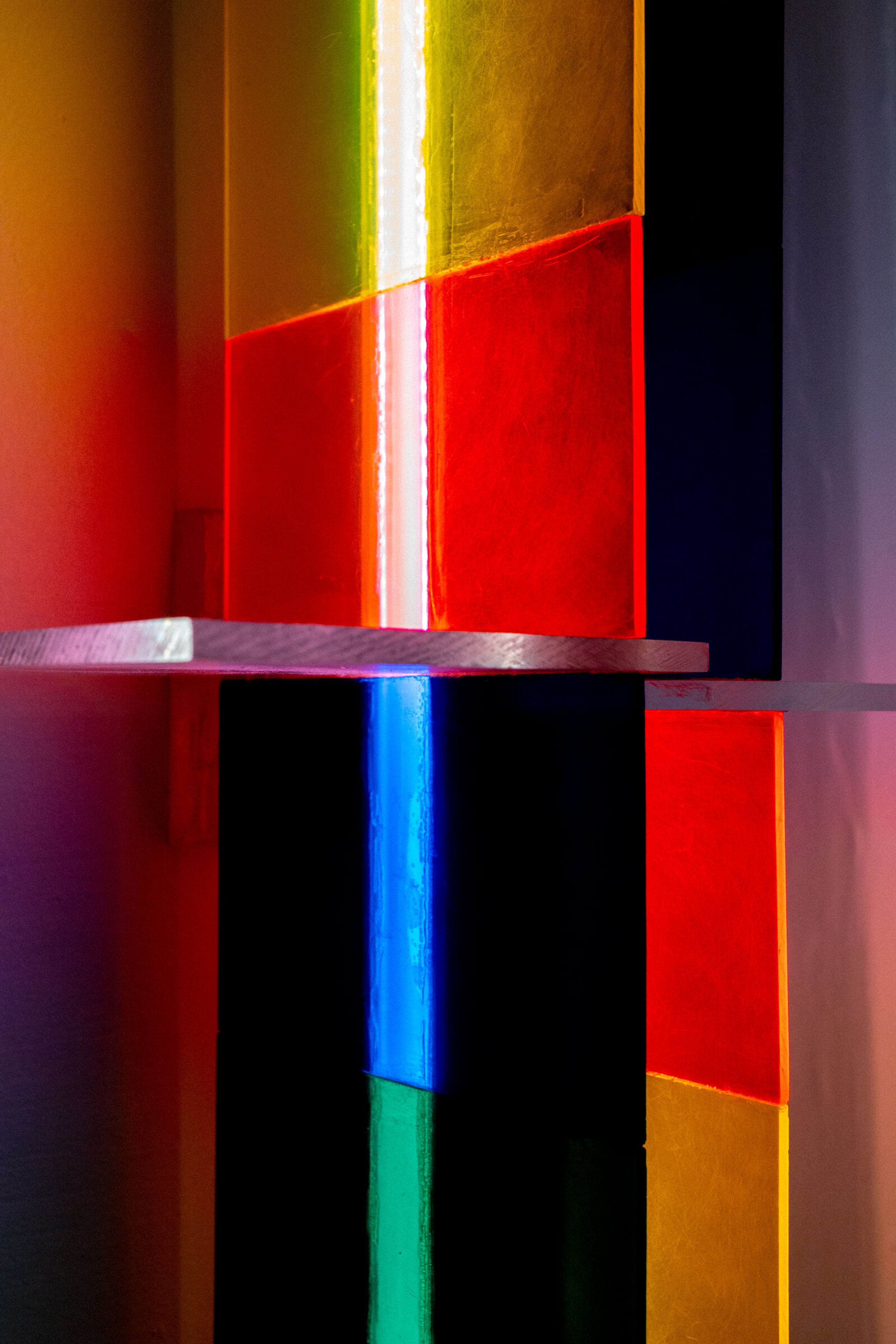 Close-up of irreversible's color blocks: yellow, red, orange, green, and blue panels arranged in a grid around a central bright streak