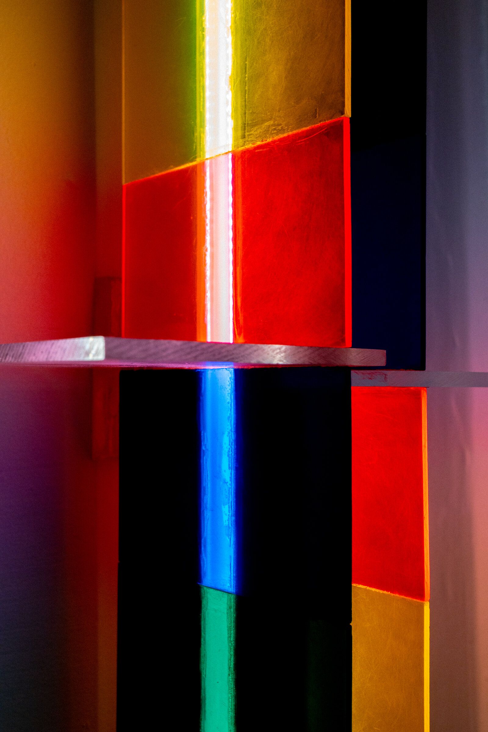 Close-up of irreversible's color blocks: yellow, red, orange, green, and blue panels arranged in a grid around a central bright streak