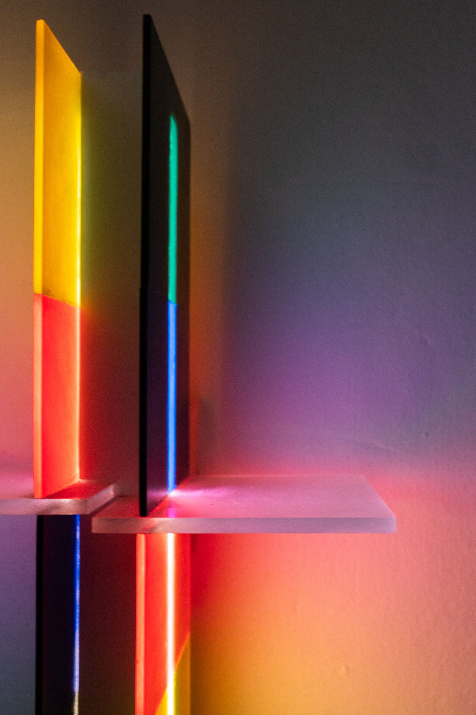 Side view of irreversible showing its perpendicular construction: two colored faces meeting at a 90-degree angle, the central LED visible at the seam
