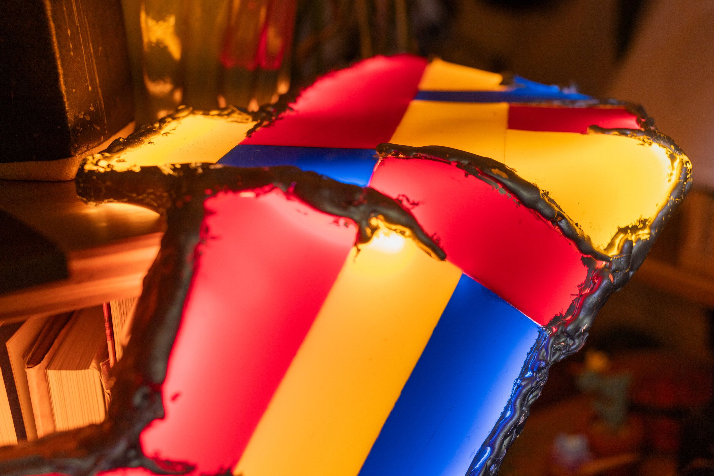 Top-down view of shelf life: a mosaic of red, yellow, and blue rectangles in an asymmetric grid pattern, edges molten