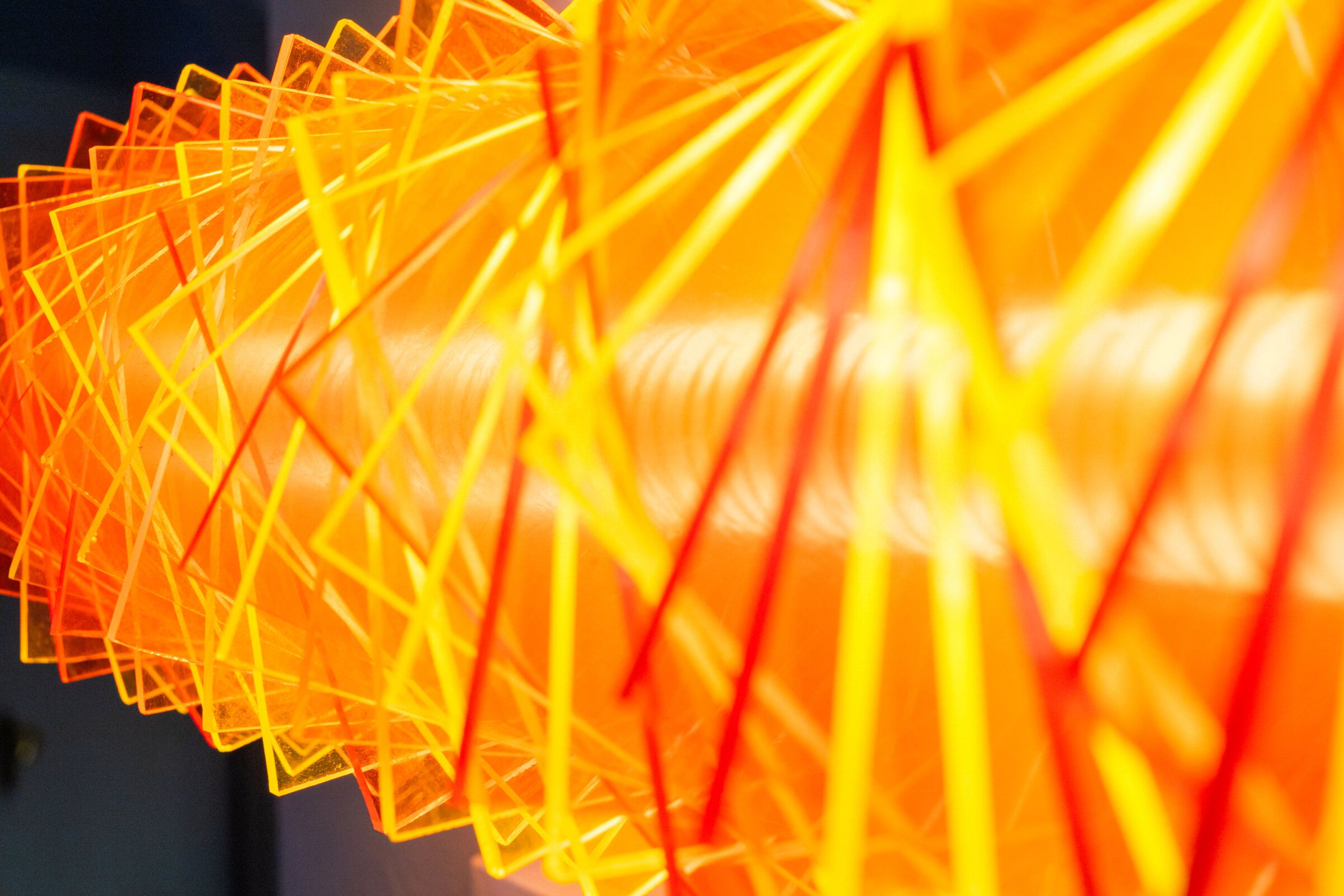 Close-up of radiator II from below: ends of the rotated plates fan outward in yellow and red and orange, the warm core visible behind them