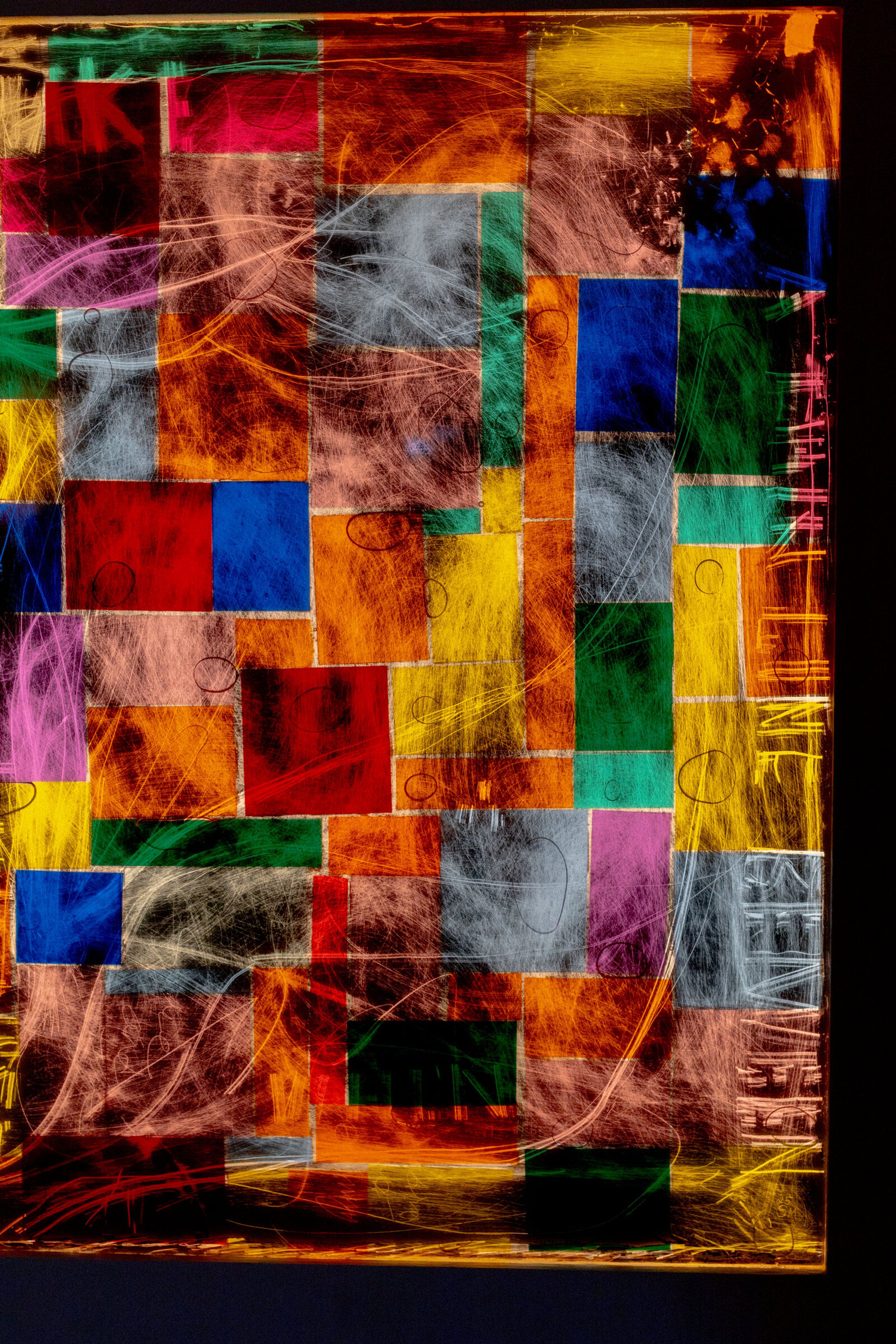 Vertical close crop of genius madness mirror: colored squares more strongly saturated, scratched white gesture moving across, edge of frame visible