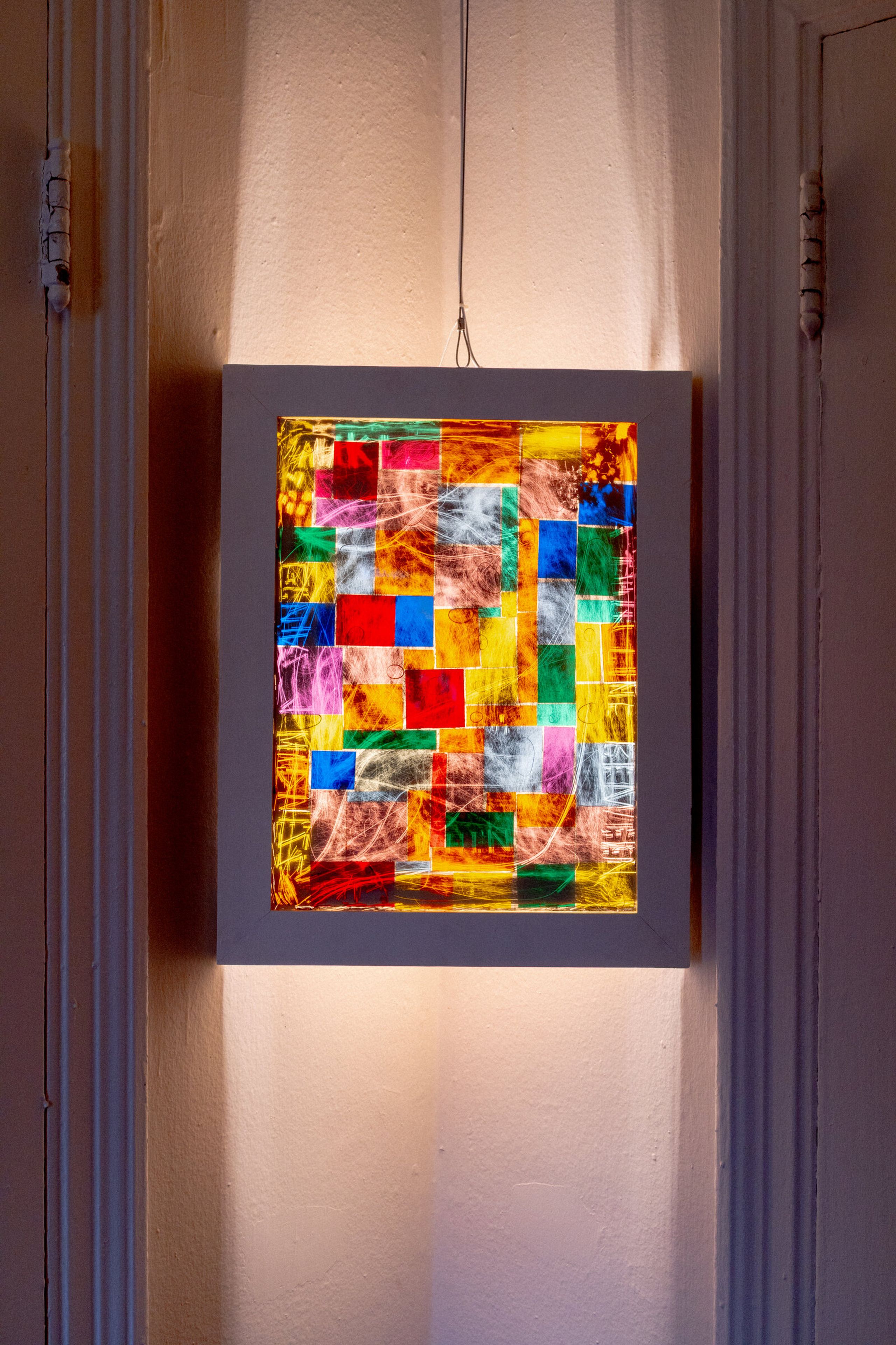 Closer view of genius madness mirror: colored squares stacked in a loose grid, white scratched marks moving across the surface, the frame visible around all four edges