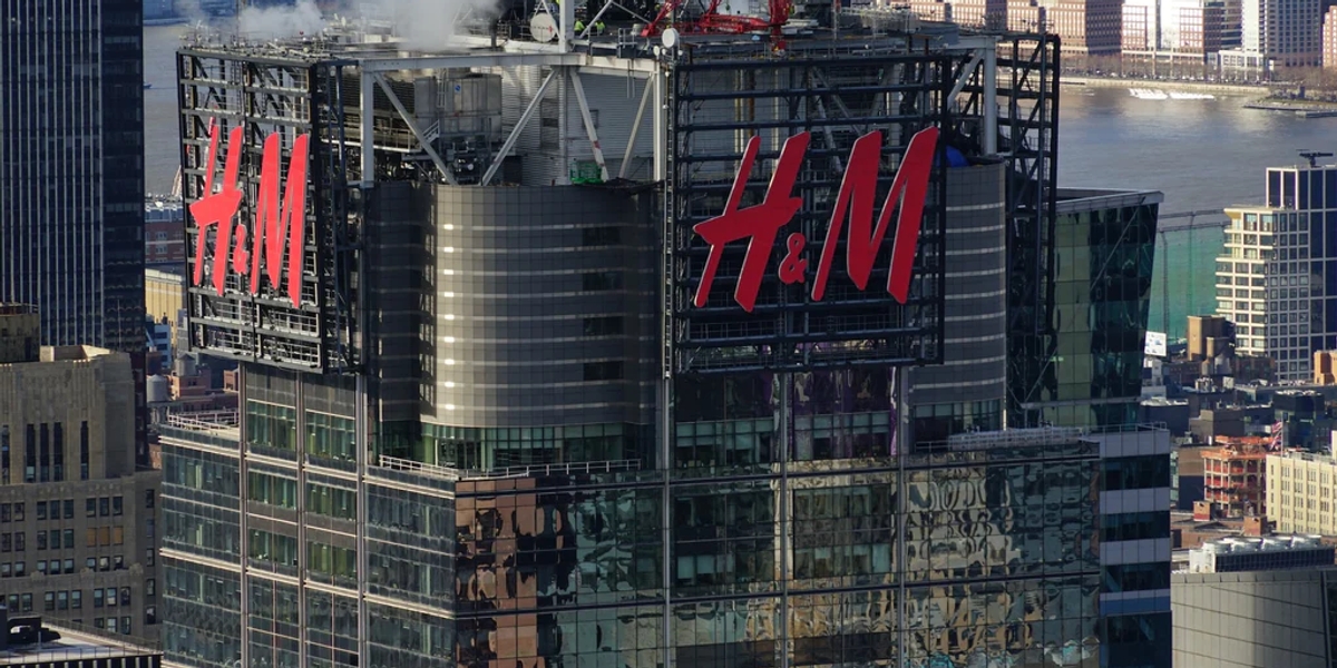 A glass office building with the red H&M logo on it 