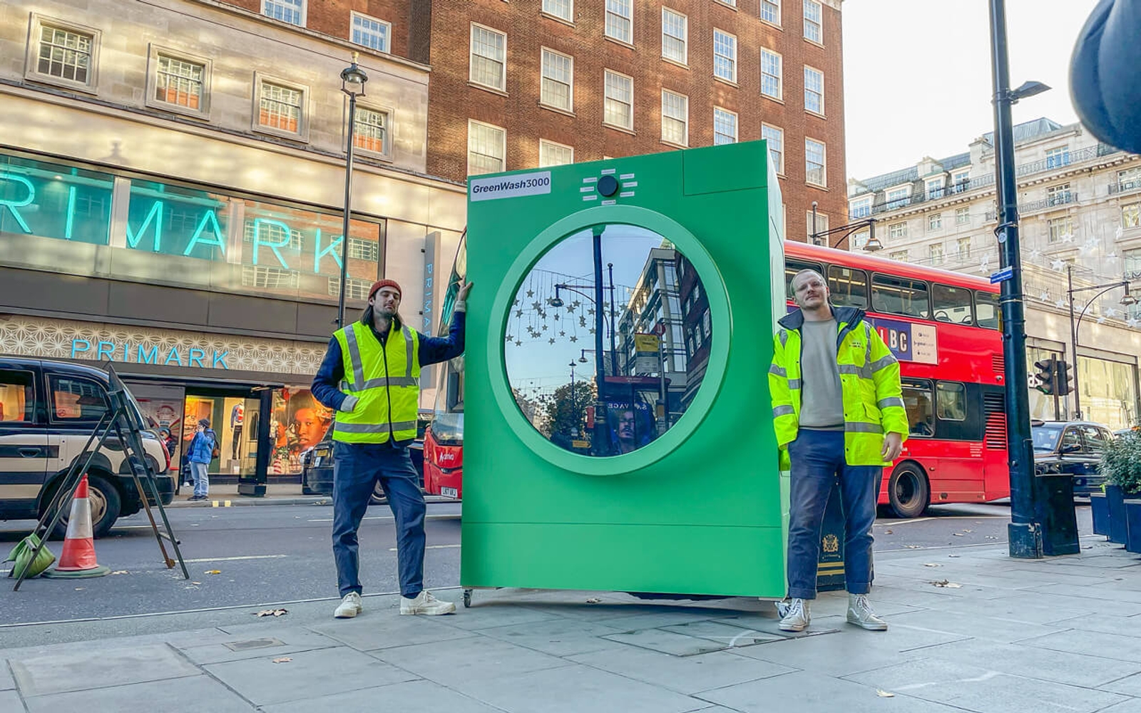 Founders Hugo and Thomas standing next to the GreenWash3000 on Oxford Street