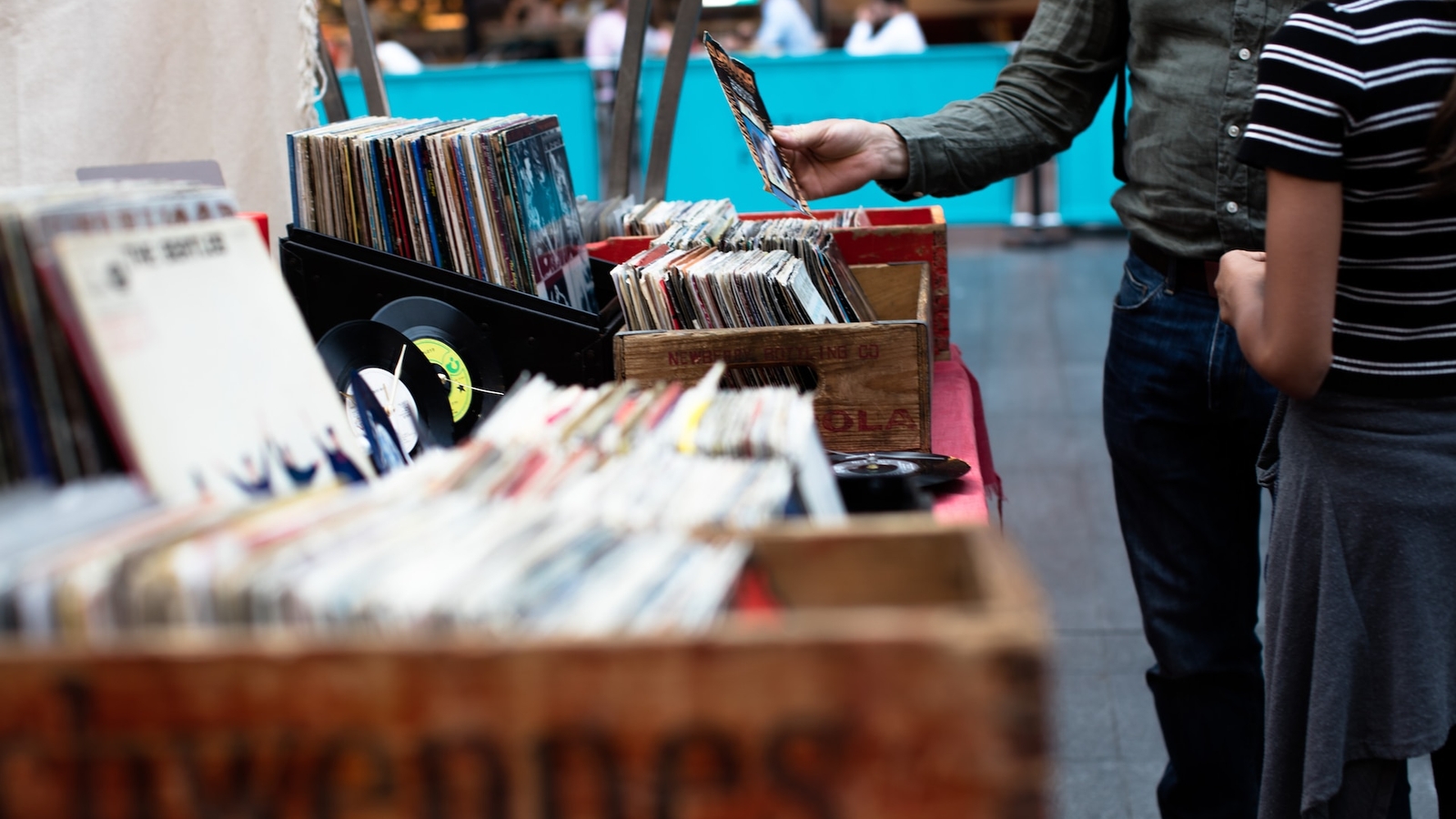 Someone picking out records at a second hand stall