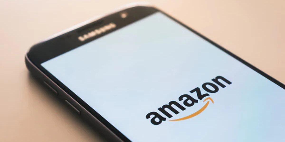 A Samsung smart phone with the Amazon logo on the screen