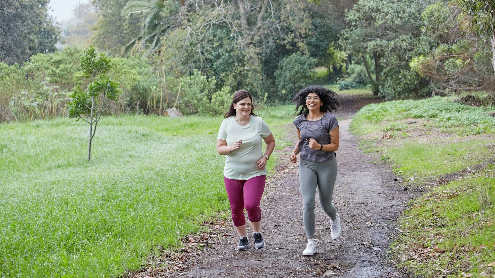 Two women running in a park