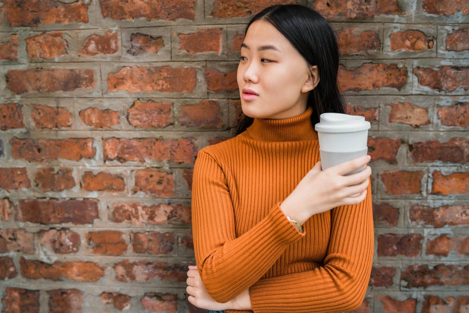 Girl holding a reusable coffee cup