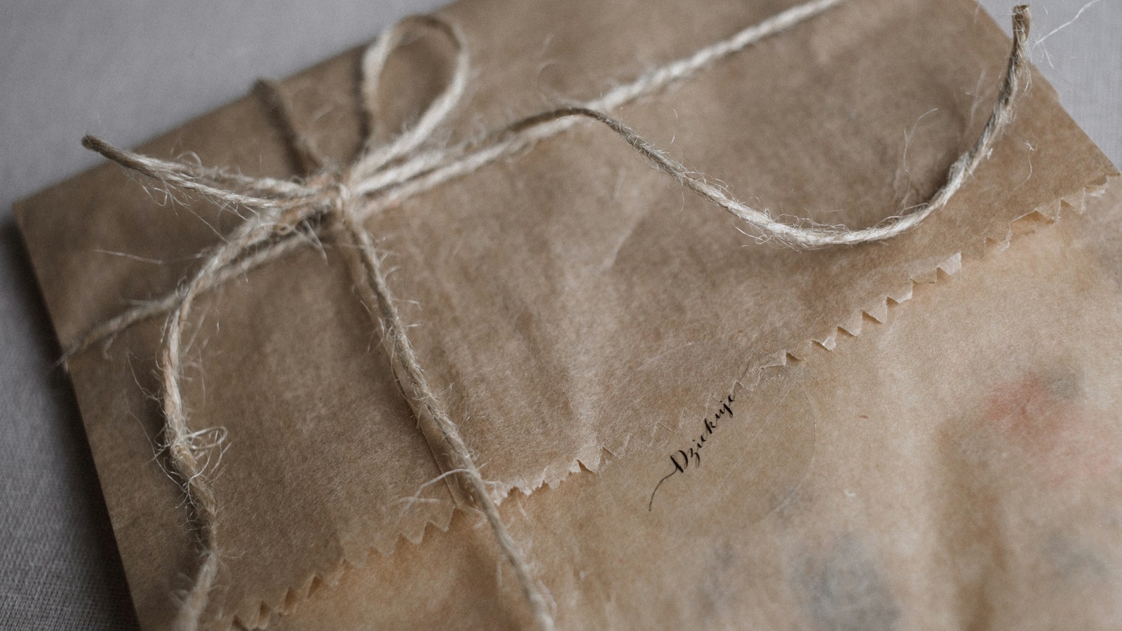 A gift wrapped in brown paper and string