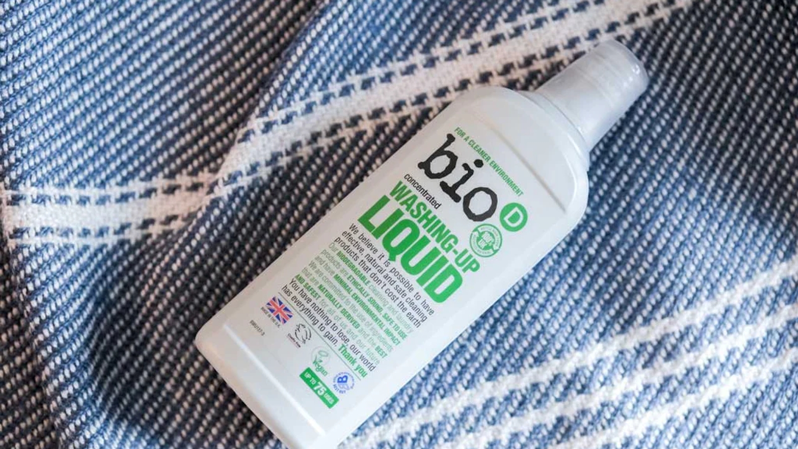 A bottle of bio-D washing up liquid on a blanket