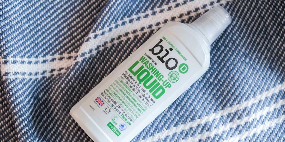 A bottle of bio-D washing up liquid on a blanket