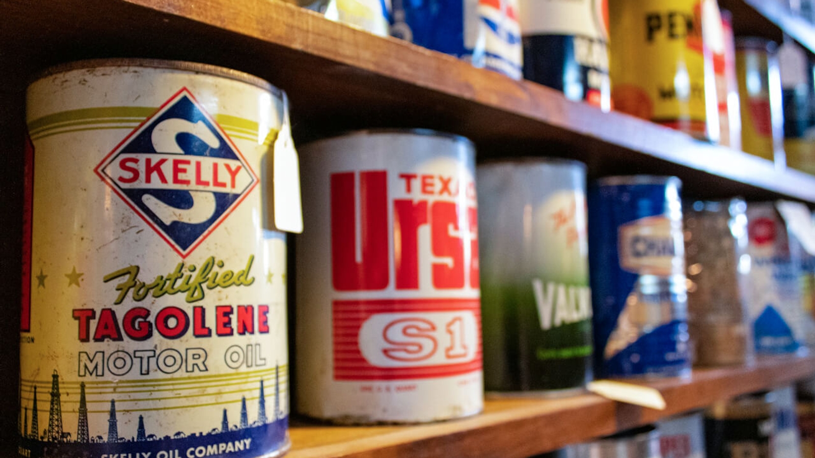 A variety of tin paint cans on shelves
