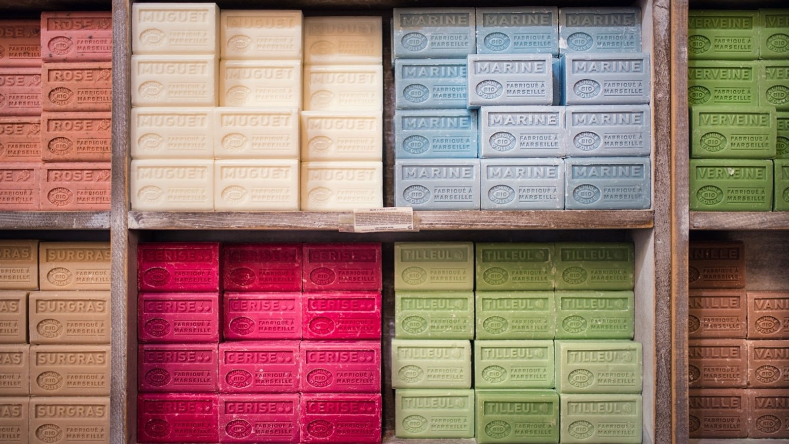 Different coloured soap bars stacked on shelves