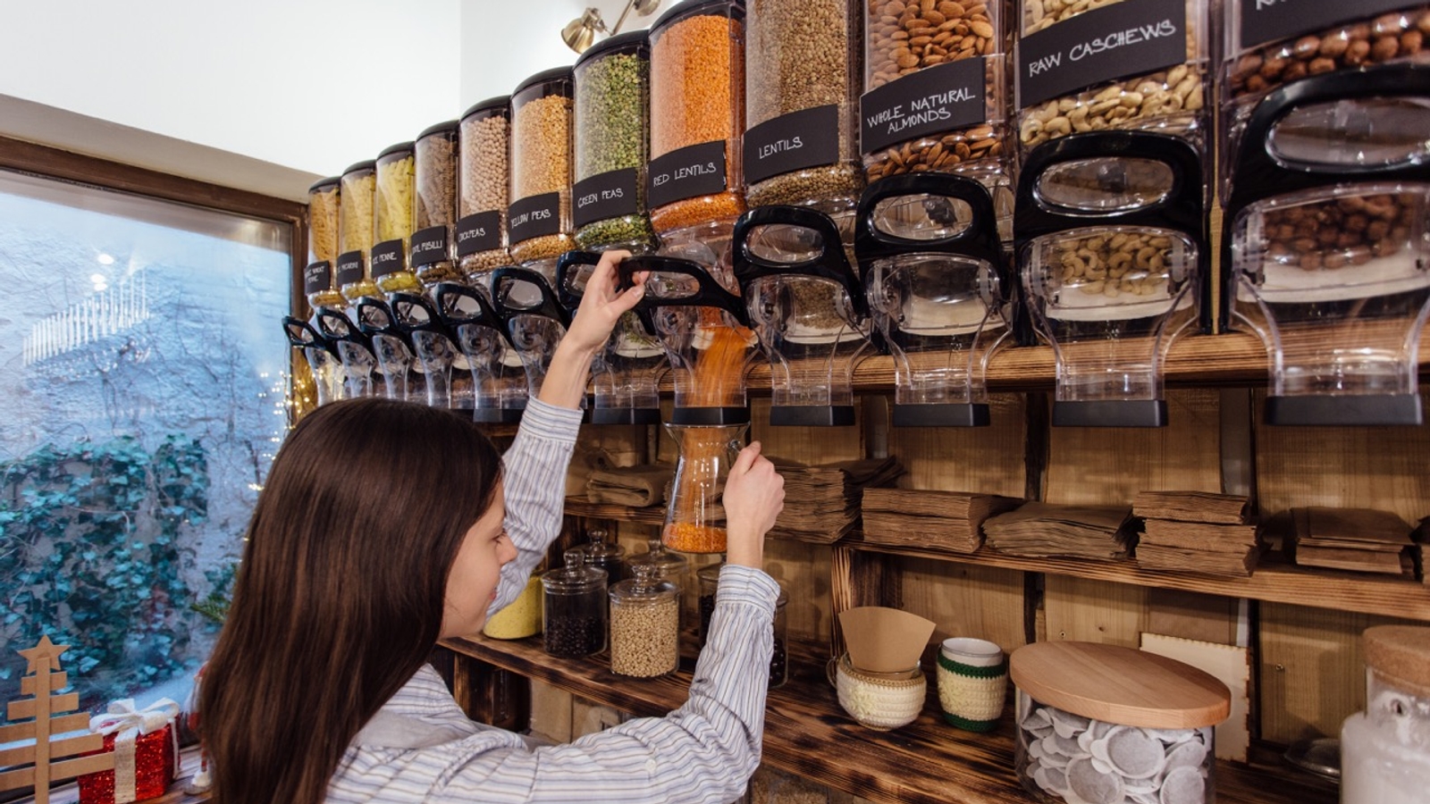 A photo of someone filling a container in a refill shop