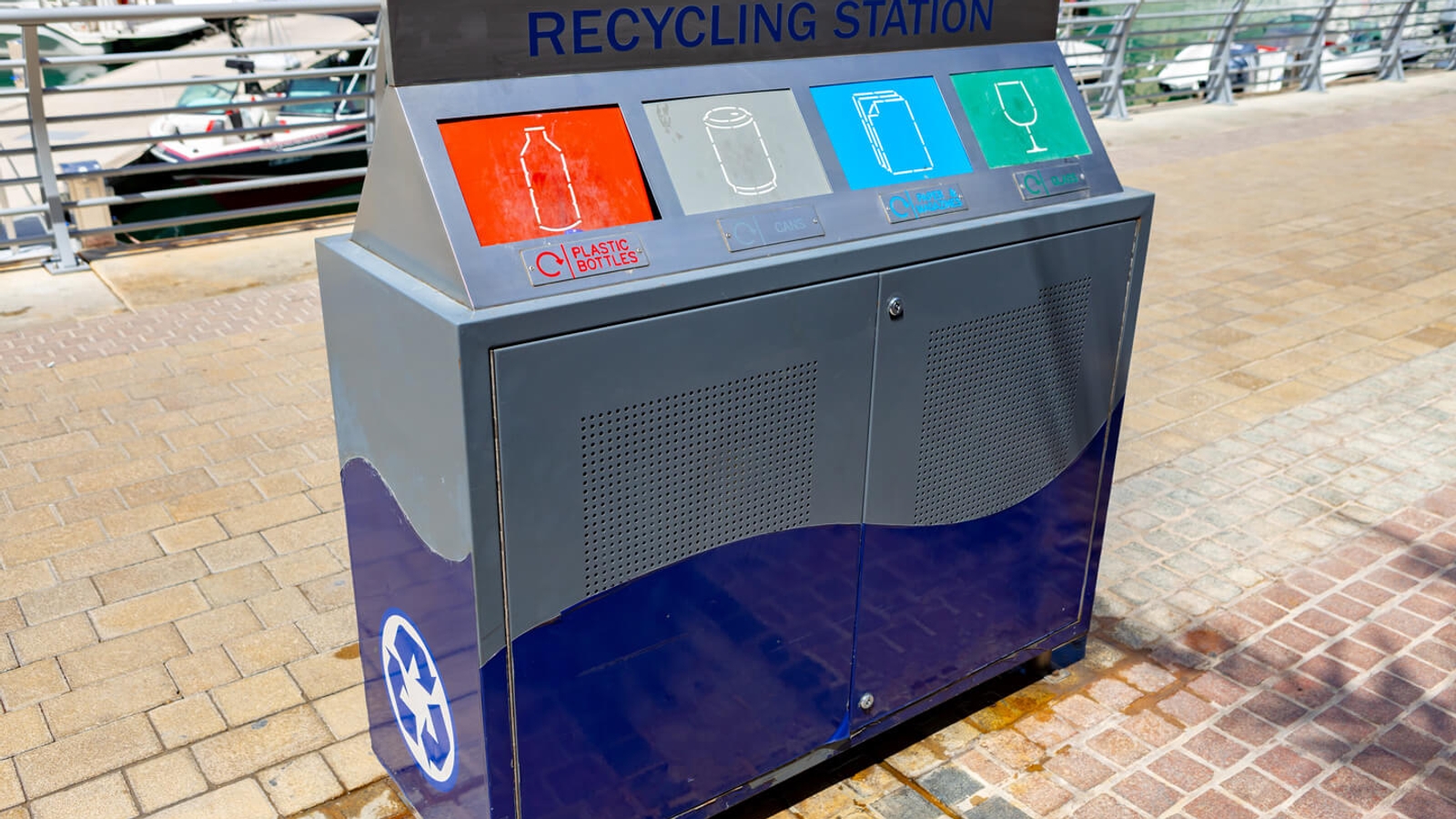 A 'recycling station' bin outside with different holes for types of recycling