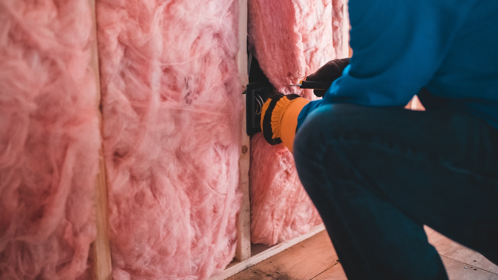 Home Insulation Being Applied To A Wall