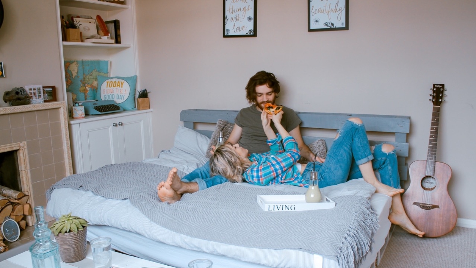 Couple In Bed Eating Pizza