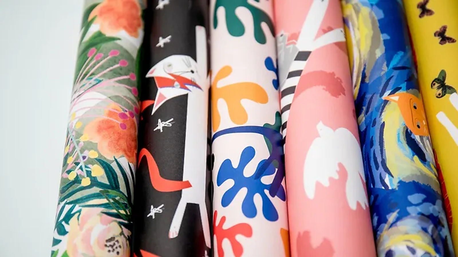 Several colorful rolls of wrapping paper