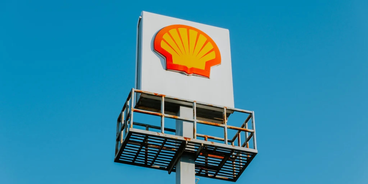 A metal Shell sign set against a blue sky 
