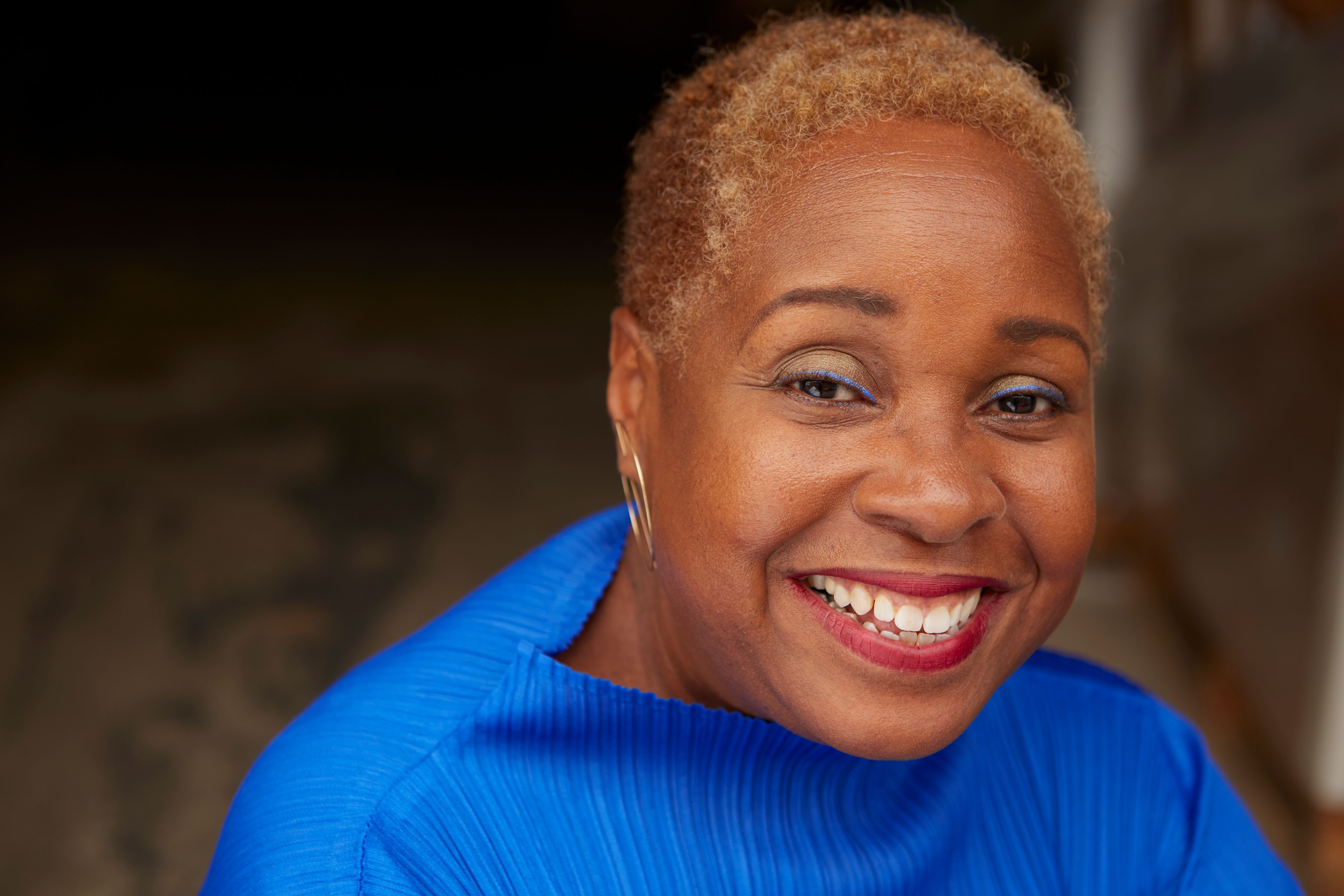Prof. Mabel Wilson headshot, wearing a bright blue shirt.