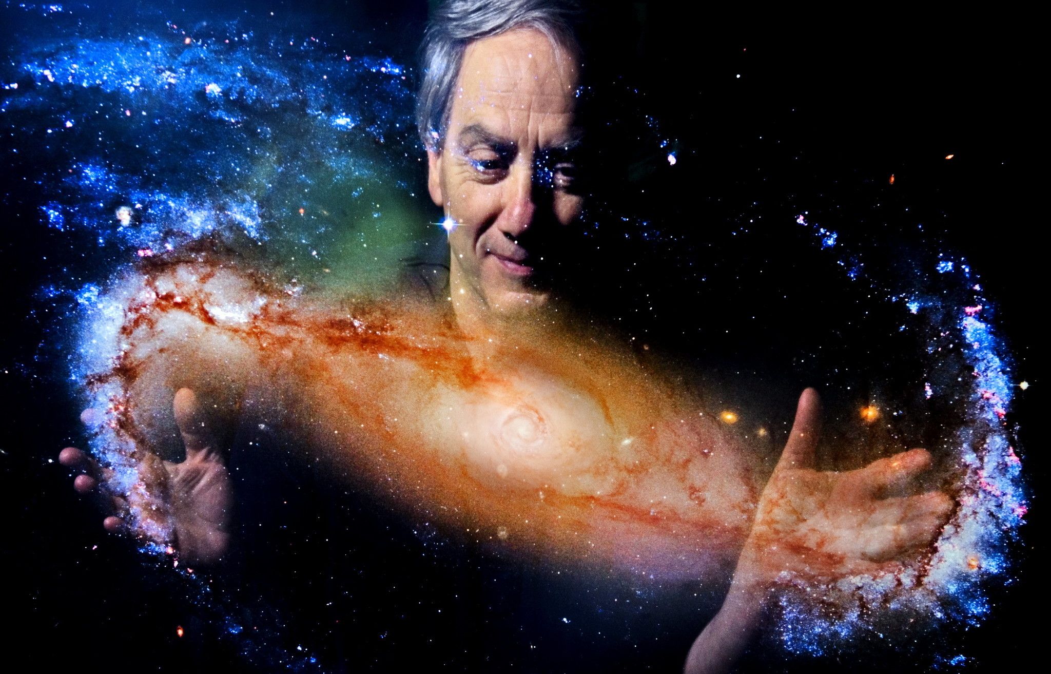 Dr. Mario Livio holding a galaxy
